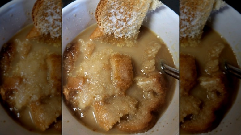 Bread and coffee in a mug with spoon