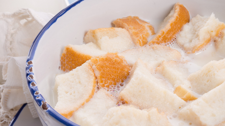 Pieces of white bread served with milk in a bowl