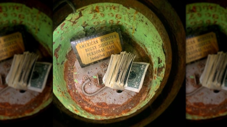 View into Formosa Cafe safe showing wad of cash and sign saying it was mobster Bugsy Siegel's safe