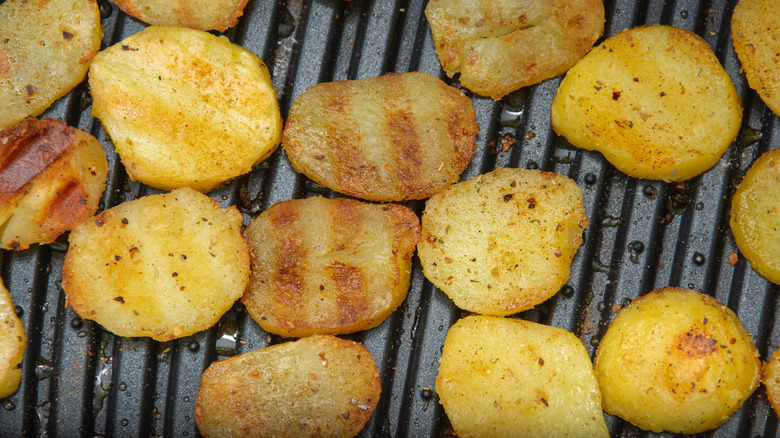Closeup of slices of potatoes on a grill
