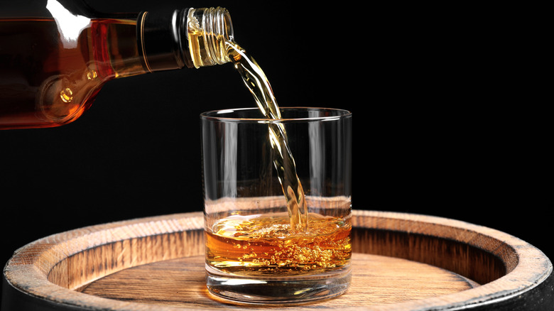 Pouring whiskey into a glass