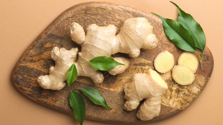 Cutting board with whole and sliced ginger