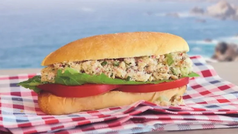Meatless Big Mac with crab meat inside placed in cardboard packaging on a marble surface