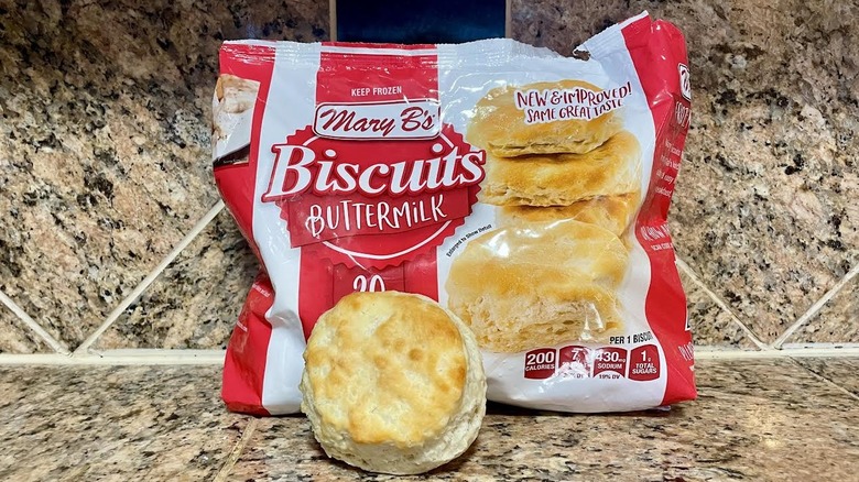 Bag of frozen Mary B's Buttermilk Biscuits with cooked one in front