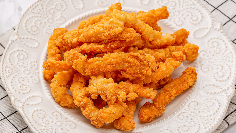 Plate of fried chicken strips.