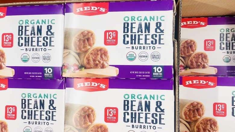 Boxes of Red's Organic Bean & Cheese Burritos stacked on store shelf