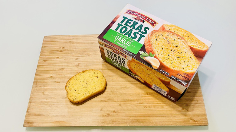 Box of Pepperidge Farm Garlic Texas Toast with cooked slice on cutting board