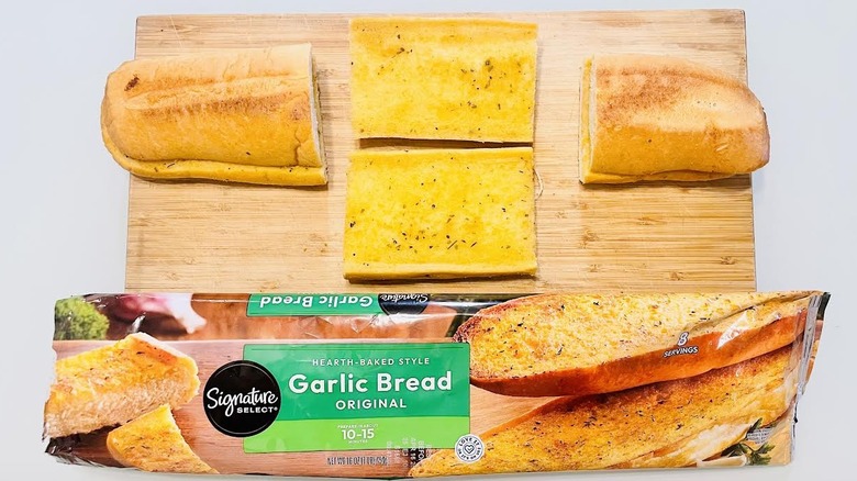 Cooked and slice loaf of Signature Select Garlic Bread with opened packaging