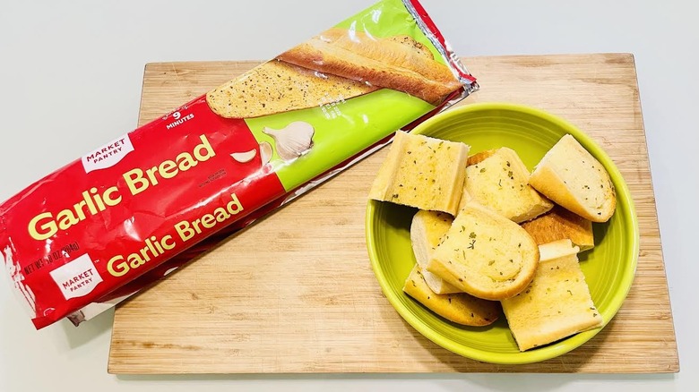 Bowl of sliced Market Pantry Garlic Bread with opened packaging