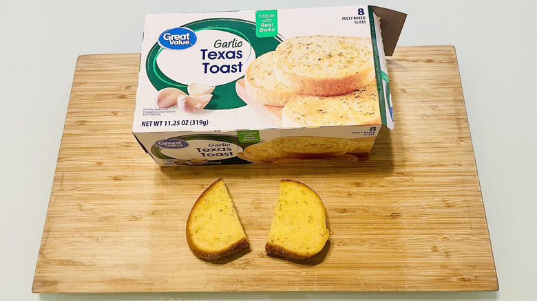 Box of Great Value Garlic Texas Toast with cooked slice on cutting board
