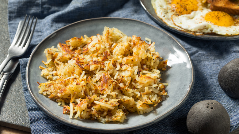 hash browns and eggs on plate