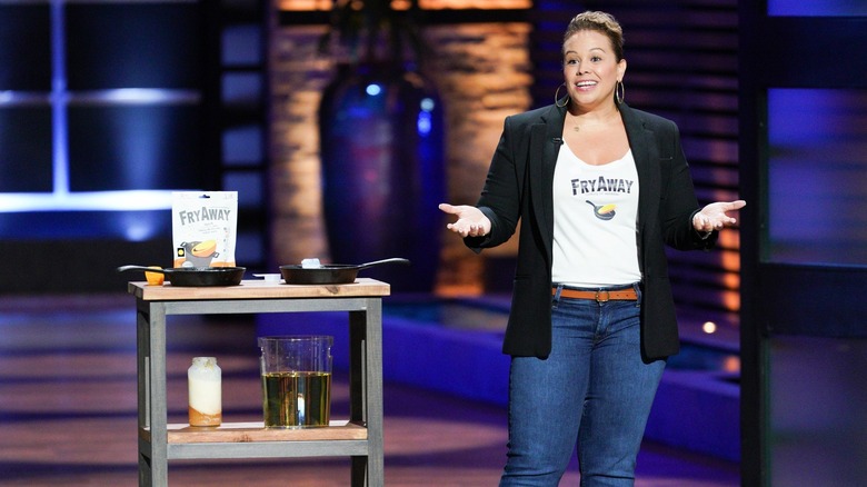 Laura Lady, the creator of FryAway, stands next to a display of her product for Shark Tank
