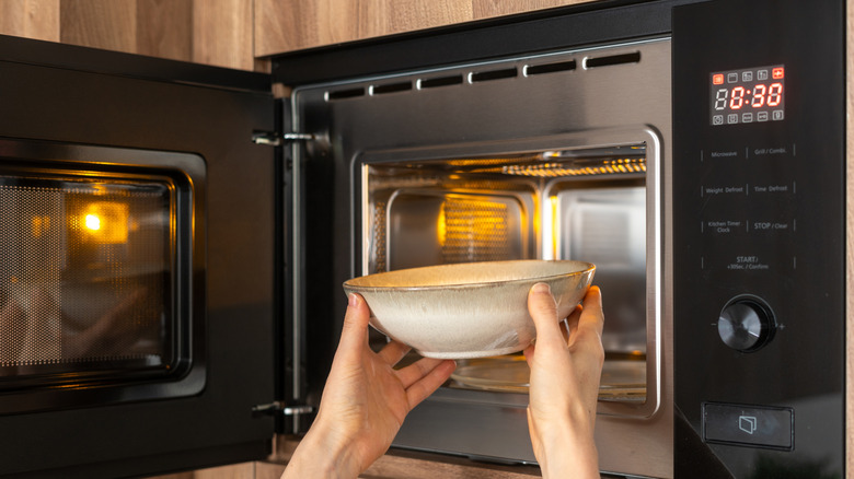 A bowl being placed in the microwave