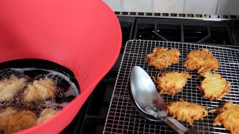 Red Frywall in pan with latkes on stove
