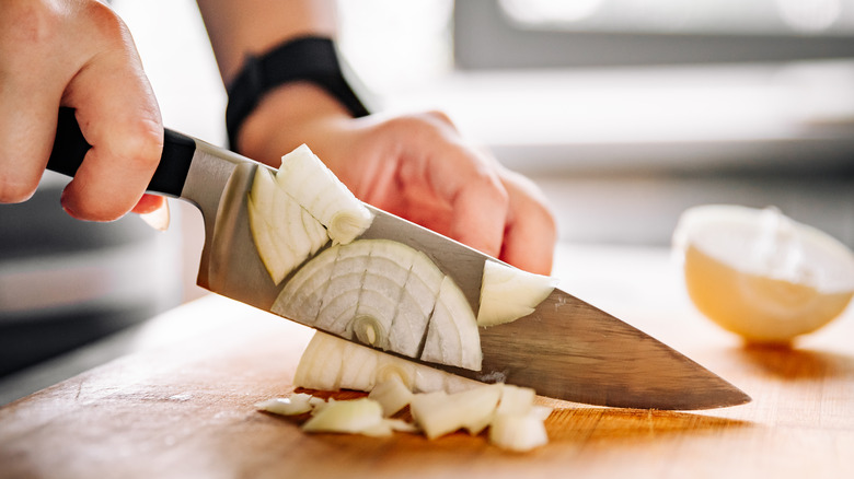 chopping onion with knife