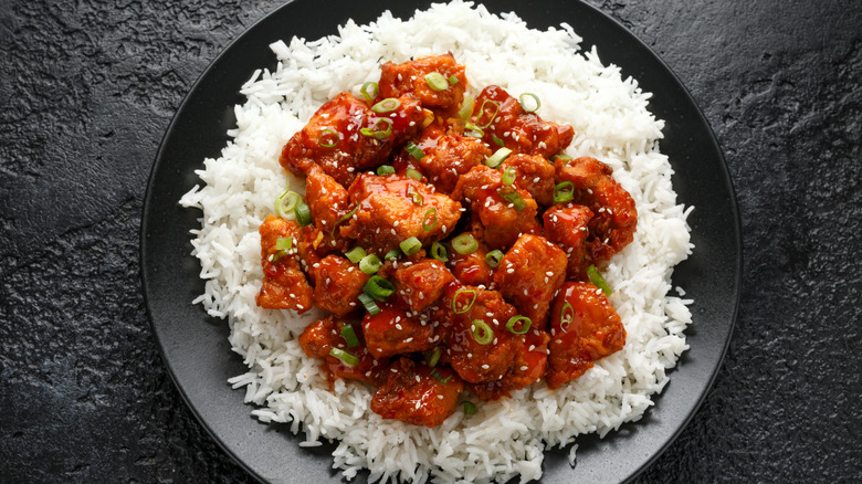 pictured serving of General Tso's chicken with rice and green onion