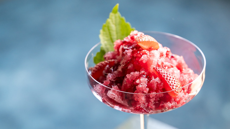 Strawberry granita with fresh strawberries and mint in a glass.