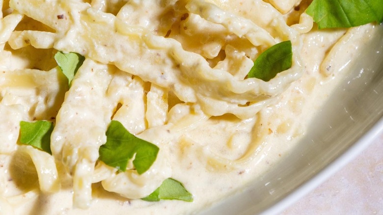 white pesto pasta with ricotta and basil