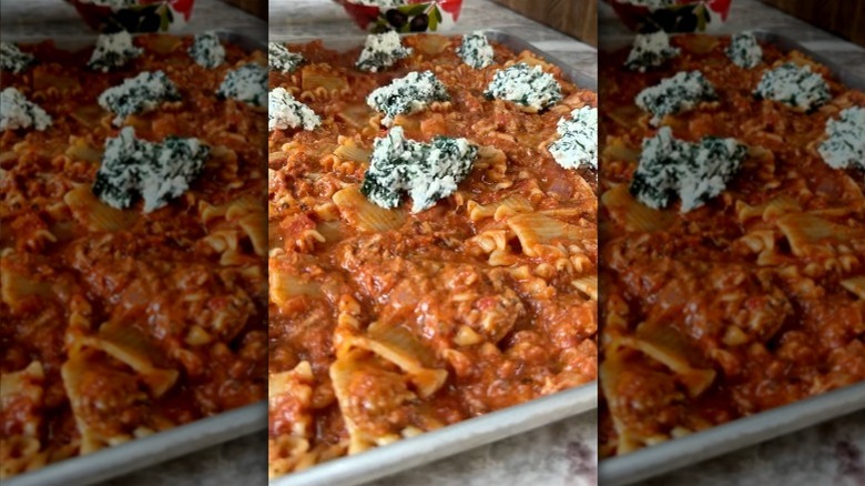 preparing lasagna in a sheet pan