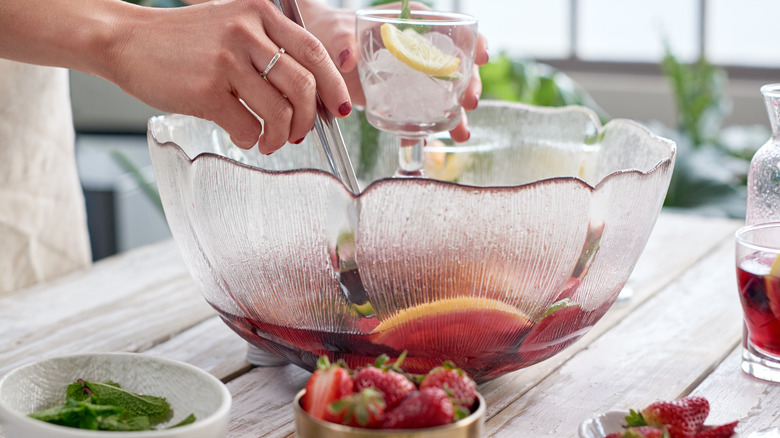 woman preparing bowl of sangria