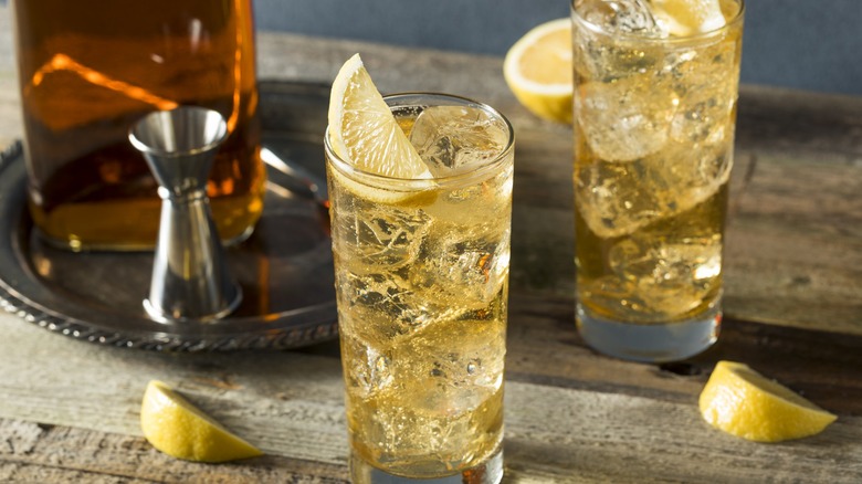 Two whiskey highballs with lemon wedges