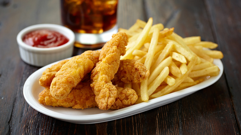 A plate of chicken tenders and fries