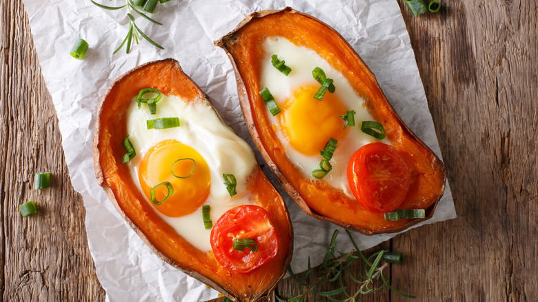 Eggs baked inside of a sweet ptoato.