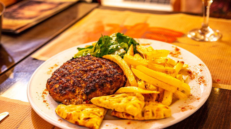Feta stuffed burger served on a plate.