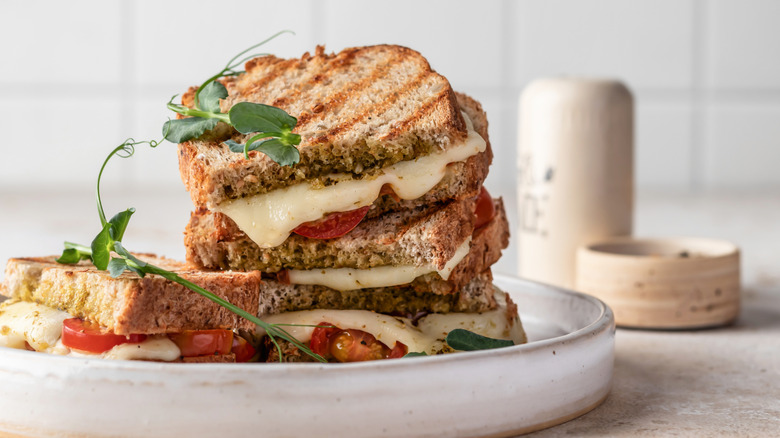 Grilled cheese with tomato, pesto, and herbs