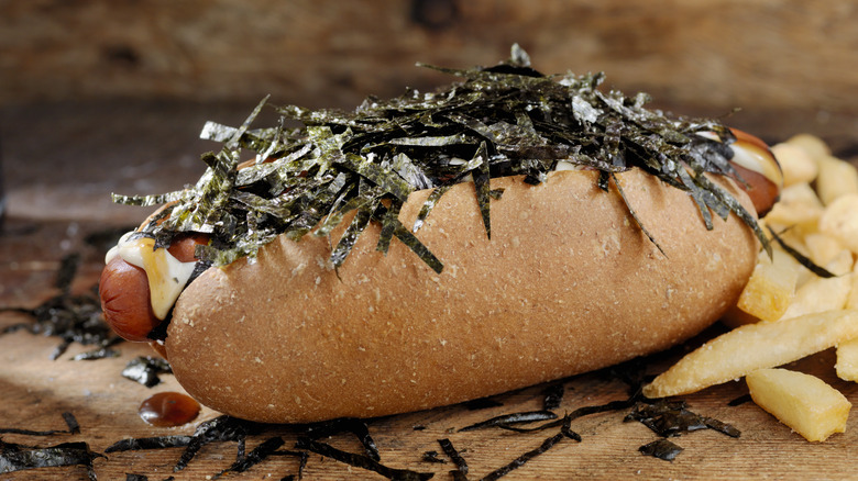Japanese hot dog topped with seaweed and mayo