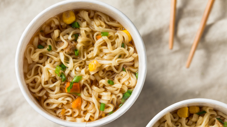 White bowl of ramen noodles with soup and vegetables