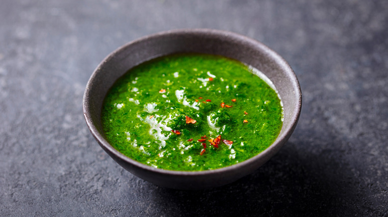 A bowl of bright green chimichurri.