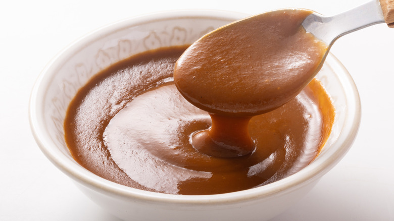 A thick demi-glace in a white bowl