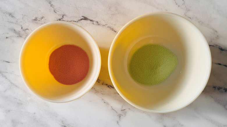 Red and green Jell-O powder in separate bowls