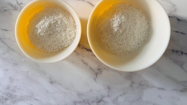 Two bowls full of shredded coconut