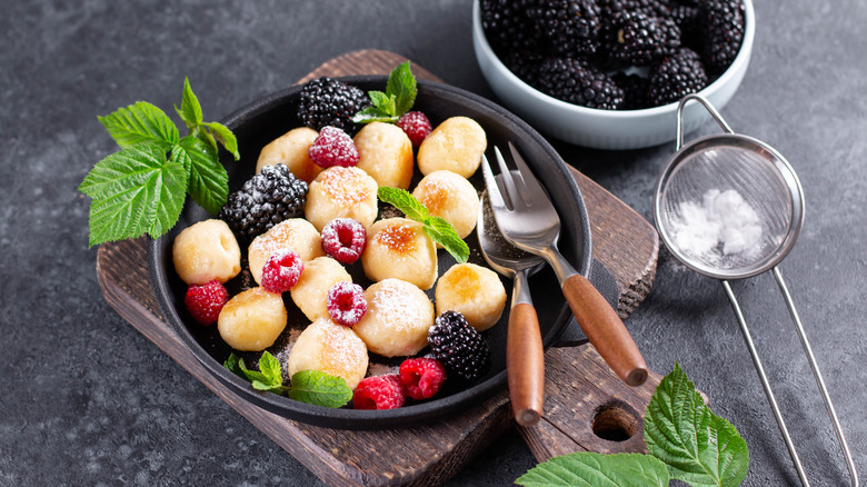 sweet gnocchi with berries and utensils