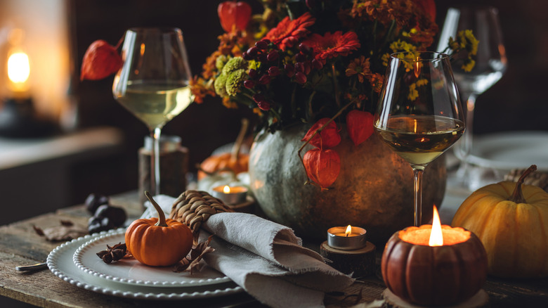 A dinner table decorated with fall decor