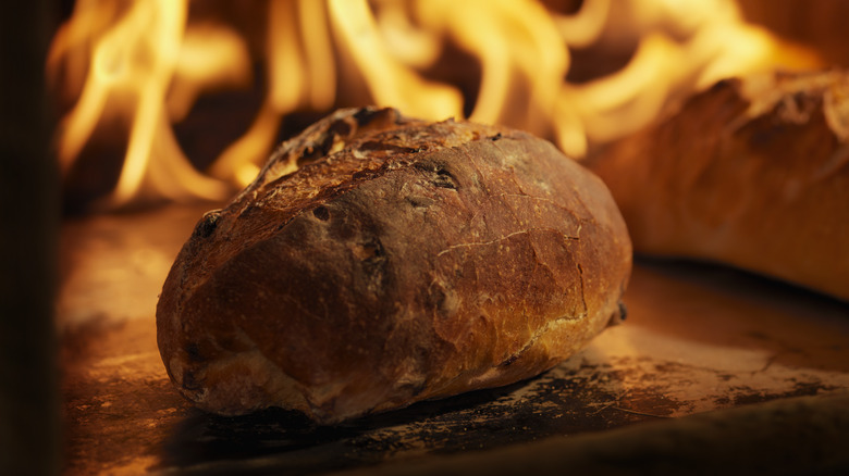 bread in an oven surrounded by fire