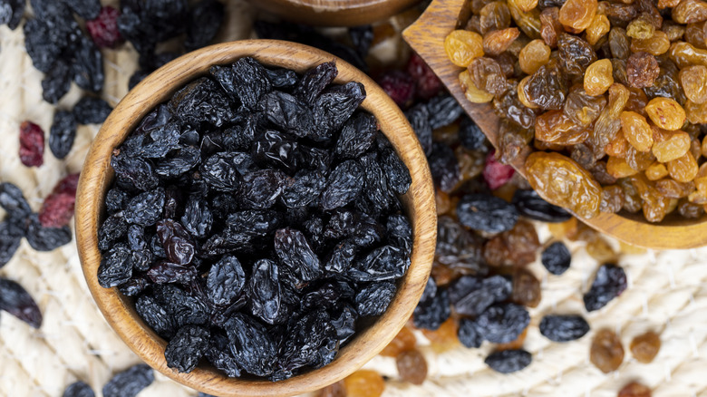 various colors of raisins in wooden bowls