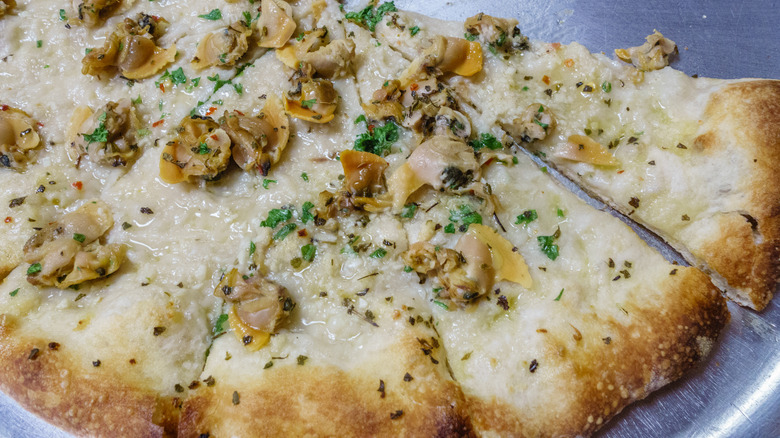 Closeup of a New Haven white clam pizza.