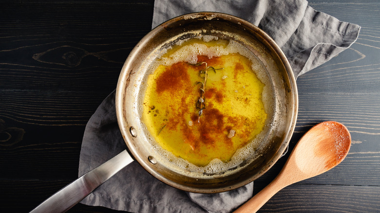 Butter browning in a pan alongside aromatics.