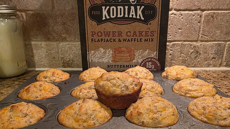 McGriddle muffins in a muffin tin sit before a box of Kodiak pancake mix.