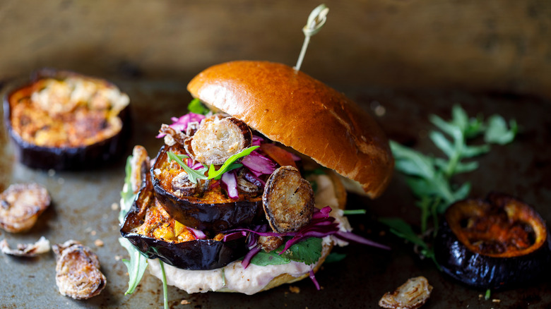 burger with roasted veggies and crispy toppings