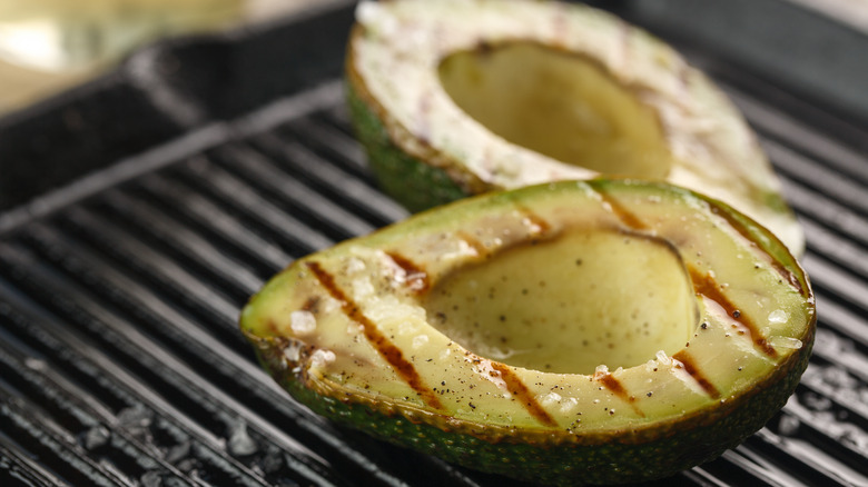 Closeup of charred avocados on the grill