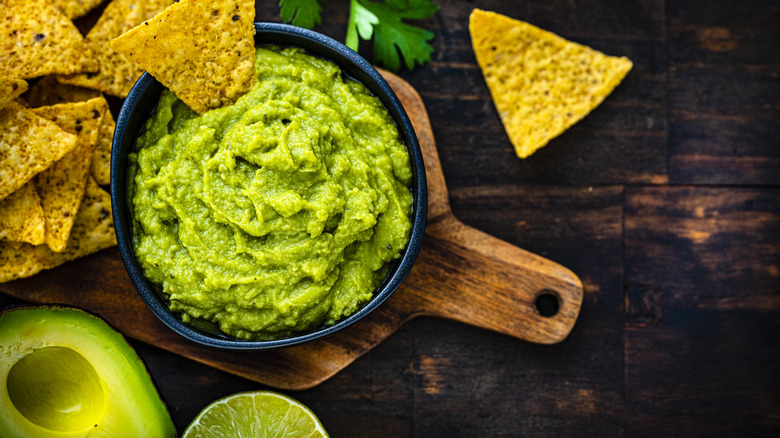 Overhead view of avocado and guacamole in a bowl 