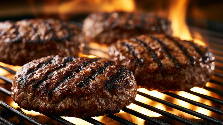 Burger patties searing on grill.