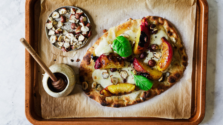 Flatbread on baking sheet with toppings