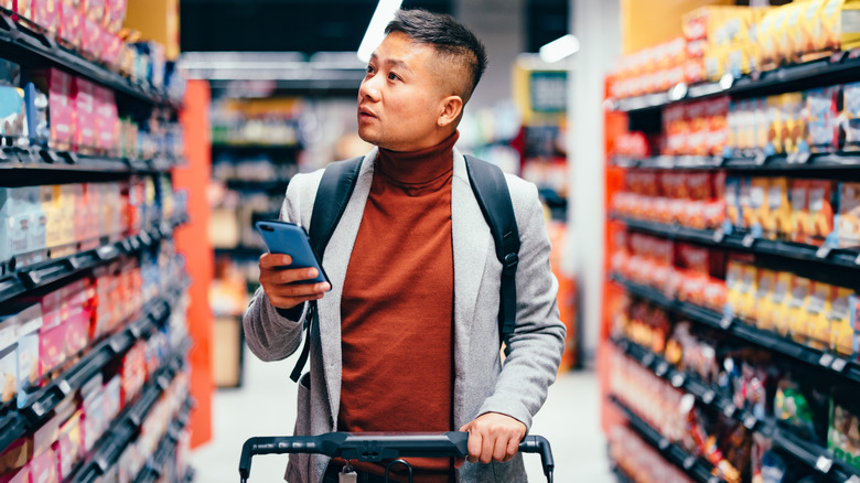 Grocery store shopper with cell phone