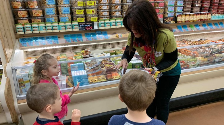 Trader Joe's employee hands out samples to children