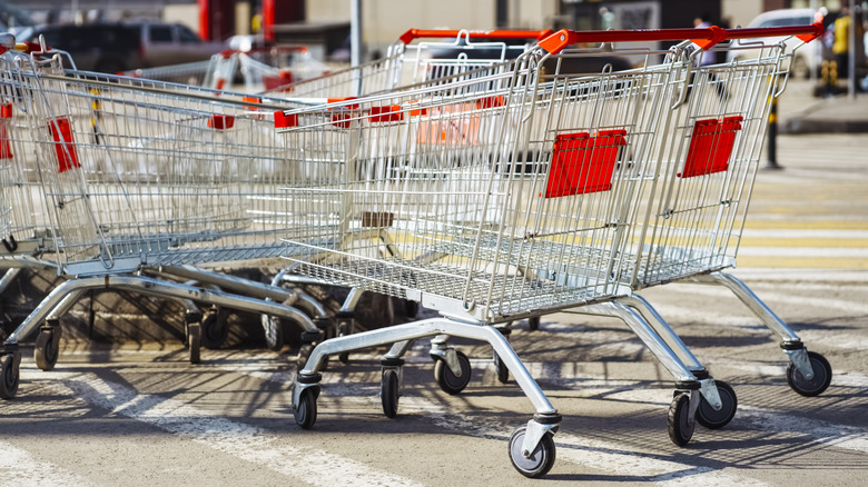 Shopping carts sit in disarray in a parking lot